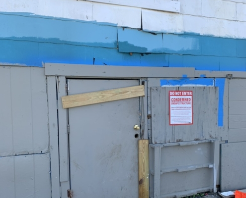 cost to own investment properties can be high or low. This photo shows a condemned property