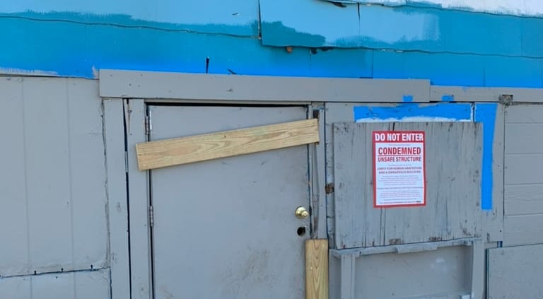 cost to own investment properties can be high or low. This photo shows a condemned property